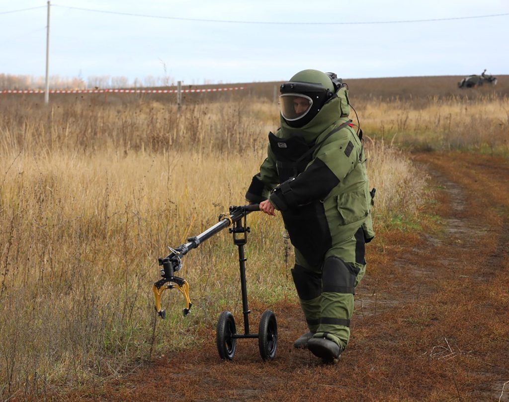 Quadruped demining robot searching through tall grass